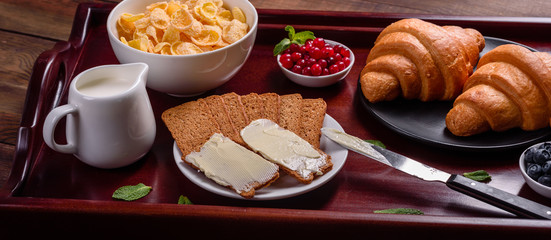 Delicious breakfast with fresh croissants and ripe berries