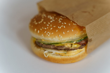 Hamburger in a paper bag. Isolate