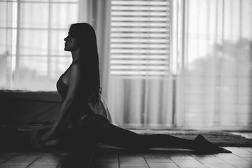 Black and white Attractive Asian woman practice yoga pigeon pose to meditation in bedroom after wake up in the morning Feeling so comfortable and relax,Yoga for Healthcare Concept