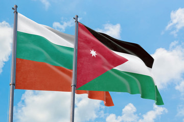 Jordan and Bulgaria flags waving in the wind against white cloudy blue sky together. Diplomacy concept, international relations.