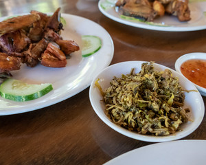 Selection of burmese dishes in rural Myanmar with skinny chicken and traditional soup