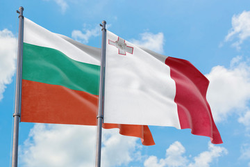 Malta and Bulgaria flags waving in the wind against white cloudy blue sky together. Diplomacy concept, international relations.
