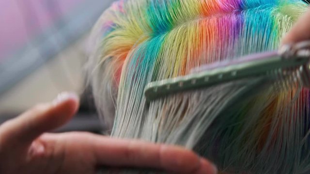 Coloring hair in a barbershop. Multicolored dyeing. A short pixie haircut.