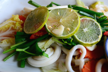 Delicious Squid Spicy Salad Dish with chilli sauce spicy herbs