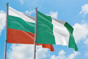 Nigeria and Bulgaria flags waving in the wind against white cloudy blue sky together. Diplomacy concept, international relations.