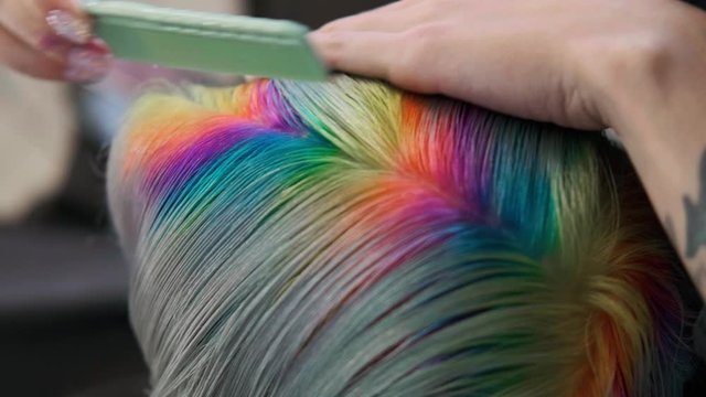 Coloring hair in a barbershop. Multicolored dyeing. A short pixie haircut.