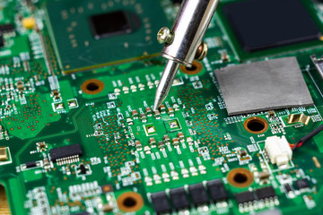 soldering iron for repairing electronic of the computer circuit board concept technology of computer circuit hardware