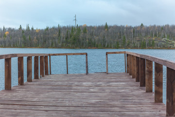 Naklejka premium Pier on the lake. Sami, saami village on the Kola Peninsula, Russia. Tourist ethnographic parking. Settlement Old Titovka, Murmansk region.