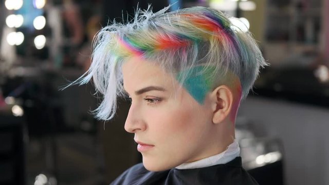 Coloring hair in a barbershop. Multicolored dyeing. A short pixie haircut.
