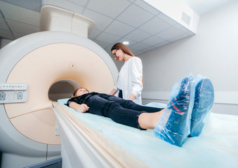 Young female doctor and child in MRI room 