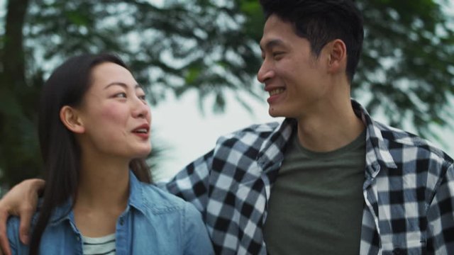Handheld view of Vietnamese couple spending time together outdoors. Shot with RED helium camera in 8K 