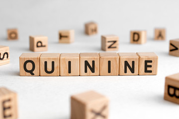 Quinine - words from wooden blocks with letters, quinine concept, white background