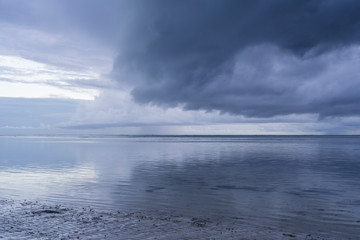 Cloudy sky during sunrise and sea water on the island of Zanzibar, Tanzania, Africa