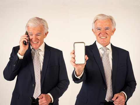 Senior Man Wearing Suit Using Mobile Phone And Showing The Screen´s Device. This Photo Has Been Created From Two Images Merged On Photoshop. Same Model In Two Different Actions