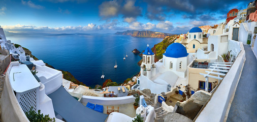 Fira town on Santorini island, Greece. Incredibly romantic sunrise on Santorini. Oia village in the...