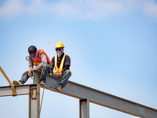 Builder welding on high-rise steel frame