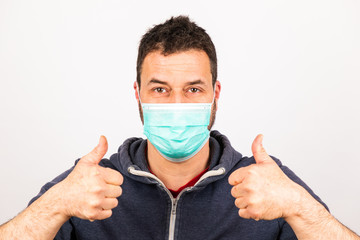 man with a mouthguard with thumbs up isolated against white background