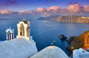 Fototapeta premium Fira town on Santorini island, Greece. Incredibly romantic sunrise on Santorini. Oia village in the morning light. Amazing sunset view with white houses. Island of lovers