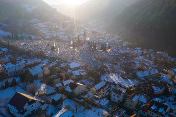 Aerial drone shot of Brasov historical neighborhood Schei at sunset on a beautiful winter day