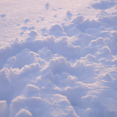 Winter texture closeup of a white snow in sunlight. Cold weather. Pure and clean nature in minimalism concept.