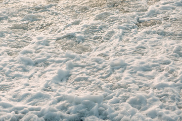 Fototapeta na wymiar Sea dirty foam on the coast