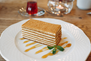Honey cake on a plate decorated with mint