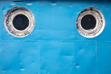 Portholes on a ship close-up. Blue ship