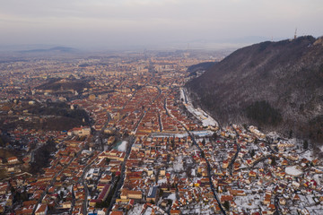 Aerial drone shot of Brasov historical neighborhood Schei at sunset on a beautiful winter day