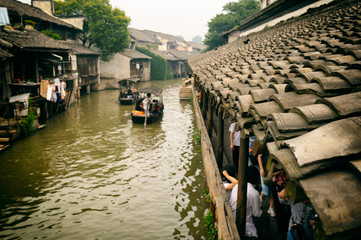 Tourists boat gondola in one of water town in China, near Shanghai