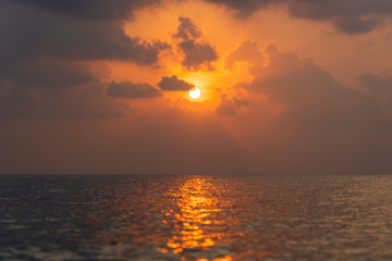 Beautiful sunset over the sea water on the island of Koh Phangan, Thailand. Travel and nature concept