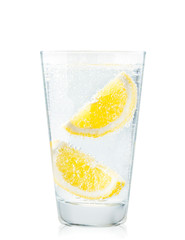 Glass of water with lemon slices in close-up on a white background. Isolated