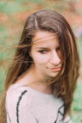 Fototapeta premium beautiful woman with flowers walking through the green forest in early spring