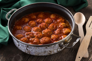 Traditional italian Meatballs served on a old wooden table. Meatballs served on a old wooden table with green napkin and spoon. Homemade delicious italian Meatballs on on a rustic table for dinner. it