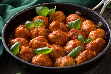 Traditional italian Meatballs served on a old wooden table. Meatballs served on a old wooden table with green napkin and spoon. Homemade delicious italian Meatballs on on a rustic table for dinner. it