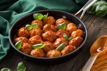 Traditional italian Meatballs served on a old wooden table. Meatballs served on a old wooden table with green napkin and spoon. Homemade delicious italian Meatballs on on a rustic table for dinner. it