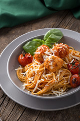 Traditional italian pasta served on a old wooden table. Pasta with Meatballs, parmesan cheese and herbs. Homemade delicious italian traditional pasta on on a rustic table for dinner. italian cuisine.