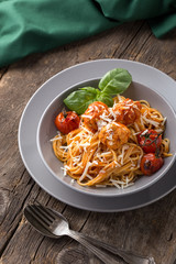 Traditional italian pasta served on a old wooden table. Pasta with Meatballs, parmesan cheese and herbs. Homemade delicious italian traditional pasta on on a rustic table for dinner. italian cuisine.