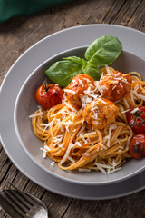 Traditional italian pasta served on a old wooden table. Pasta with Meatballs, parmesan cheese and herbs. Homemade delicious italian traditional pasta on on a rustic table for dinner. italian cuisine.