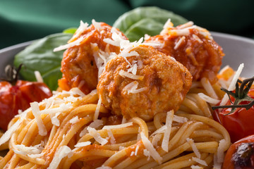 Traditional italian pasta served on a old wooden table. Pasta with Meatballs, parmesan cheese and herbs. Homemade delicious italian traditional pasta on on a rustic table for dinner. italian cuisine.