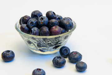 Still life photos of blueberries on a white background.