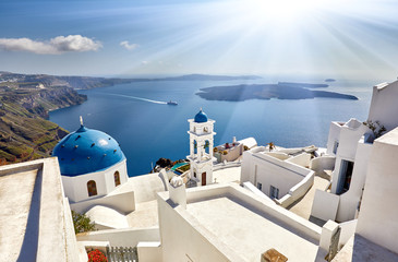 Fira town on Santorini island, Greece. Incredibly romantic sunrise on Santorini. Oia village in the sun light. Amazing sunset view with white houses. Island lovers