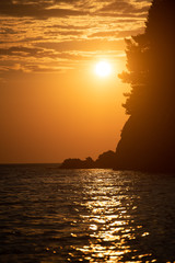 Lucice beach near Petrovac, Montenegro. Lucice landscape- sandy beach on Montenegrin coast with clear water and pine trees around on sunset.