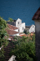 Perast, Montenegro - June 2018: The bell tower of St Nicholas Church and the village of Perast on June 18, 2018 in Perast, Montenegro.