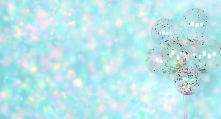 Colorful shiny confetti on festive blue background with balloons, banner. Sparkles wallpaper decor. Happy birthday, valentine, wedding invitation poster background.