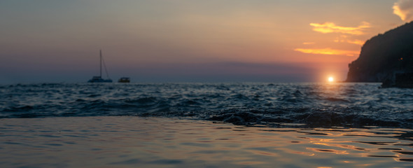 Beautiful sunset over the sea in Petrovac, coast of Montenegro