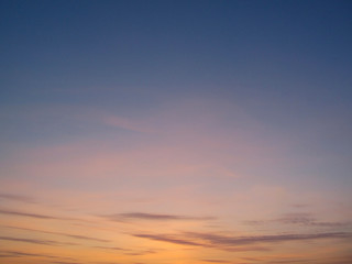 Clear sky with small clouds on the horizon at sunset. Beautiful colorful sky at sunset background.