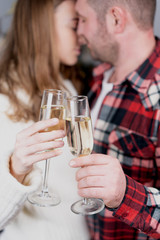 Selective focus of couple with glasses of champagne kissing in anniversary