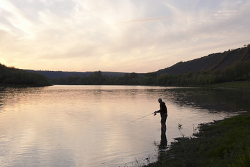Obraz na płótnie Canvas fisherman on the lake