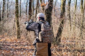 Fototapeta premium Male from private military company with rifle in the forest