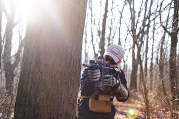 Male from private military company with rifle in the forest